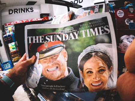 LONDON, ENGLAND - MAY 20, 2018: POV The Sunday Times front cover newspaper in British press kiosk featuring portraits of Prince Harry and Meghan Markle following the Royal Wedding lifestyle eventのeditorial素材