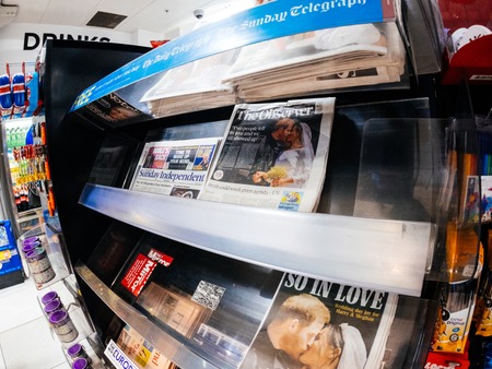 LONDON, ENGLAND - MAY 20, 2018: Front covers of British national newspapers are seen following the Royal Wedding press kiosk between Prince Harry and Meghan Markle Sunday Express The observerのeditorial素材