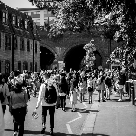WINDSOR, BERKSHIRE, UNITED KINGDOM - MAY 19, 2018: Crowd with flags and baloons walking to royal wedding marriage celebration of Prince Harry, Duke of Sussex and the Duchess of Sussex Meghan Markleのeditorial素材