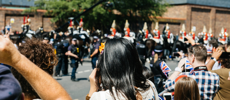 WINDSOR UNITED KINGDOM - MAY 19, 2018: Woman admiring the Royal Guards march in street around Windsor Castle prior to the procession celebrate the wedding of Prince Harry of Wales and Ms Meghan Markleのeditorial素材