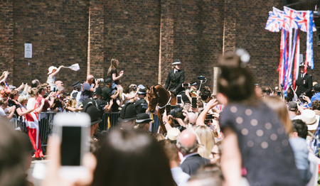 WINDSOR, BERKSHIRE, UNITED KINGDOM - MAY 19, 2018: Raised cameras and phones as carriage with newlyweds approach at royal wedding marriage celebration of Prince Harry and Meghan Markleのeditorial素材