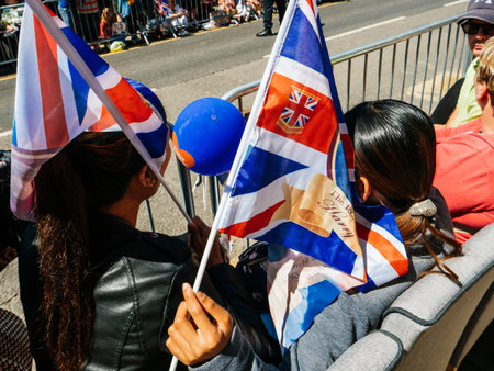 WINDSOR, BERKSHIRE, UNITED KINGDOM - MAY 19, 2018: Female asian tourists with flags at royal wedding...