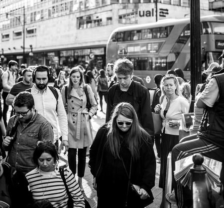 LONDON, UNITED KINGDOM - MAY 18, 2018: Black and white Oxford Circus Station man distributing latest breaking Royal Wedding news through free edition of Evening Standard Newspaperのeditorial素材