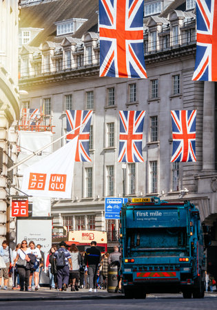 LONDON, UNITED KINGDOM - MAY 18, 2018: Garbage truck dustcart under Union Jack Flags on Regent...