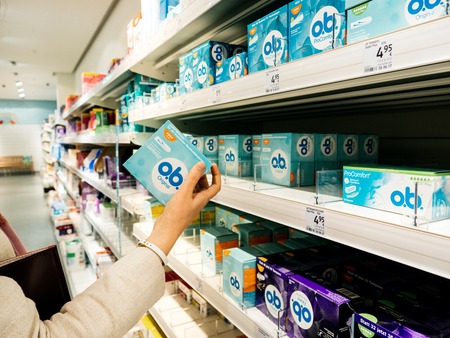 FRANKFURT, GERMANY - OCT 6, 2017: Woman hand taking from shelves a package of OB tampons from DM supermarket storeのeditorial素材