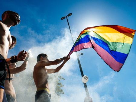 STRASBOURG, FRANCE - JUN 10, 2017: Smoke grenade and gay man waving rainvbow pride falg at Lesbian Gay Bisexual Transgender LGBT visibility march pride Festigaysのeditorial素材