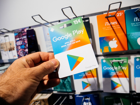 FRANKFURT, GERMANY - OCT 6, 2017: 50 Euro card in man hand point of view customer shopping for prepaid Google Play Gift card online money prepaid cards online applications computer movies musicのeditorial素材