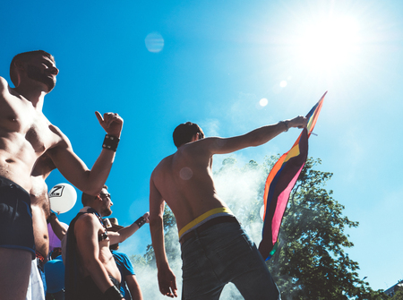 STRASBOURG, FRANCE - JUN 10, 2017: Vintage filter over caucasian excited gay men people dancing waving rainbow flag at Lesbian Gay Bisexual Transgender LGBT visibility march pride Festigaysのeditorial素材