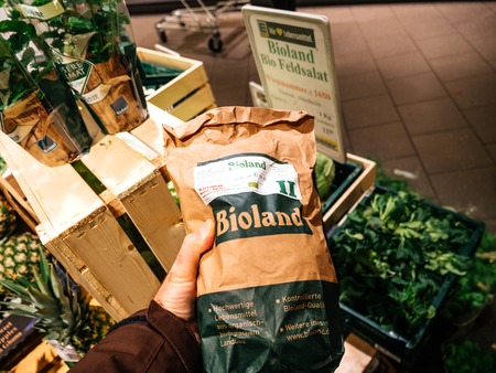 FRANKFURT, GERMANY - NOV 25, 2017: Male customer point of view buying vegan and vegetarian food in German supermarket Edeka - choosing the fresh Bioland German potatoesのeditorial素材