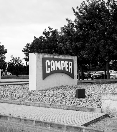 INCA, PALMA DE MALLORCA, SPAIN - MAY 8, 2018: Black and white to Camper shoe factory headquarter in Inca with logotype on totem. Camer is a footwear company with headquarters in Mallorca, Spainのeditorial素材