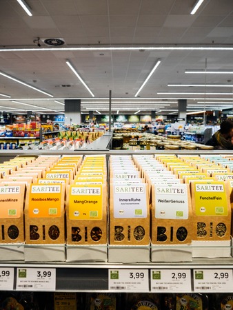 FRANKFURT, GERMANY - NOV 25, 2017: customer point of view buying bio tea in German supermarket Edekaのeditorial素材