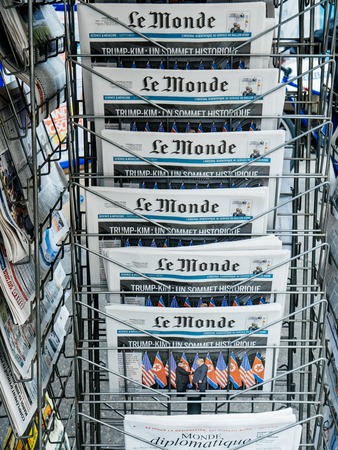 PARIS, FRANCE - JUNE 13, 2018: Stand with Le Monde newspaper at press kiosk showing on cover  U.S. President Donald Trump meeting North Korean leader Kim Jong-un in Singaporeのeditorial素材