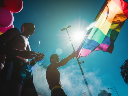 STRASBOURG, FRANCE - JUN 10, 2017: Males waving gay rainbow flag over crowd at Gay Pride LGBT marchのeditorial素材