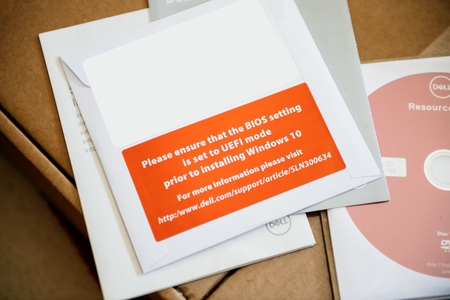 LONDON, UNITED KINGDOM - JUN 15, 2017: Unboxing of new computer box containing multiple Operating System OS DVDs and drivers on CD-driveのeditorial素材