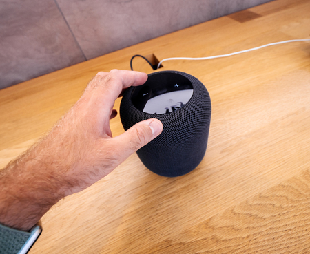 PARIS, FRANCE - JUN 30, 2018: Man hand POV holding in Apple Store the latest Apple Computers HomePod smart speaker developed computer firm push button volumeのeditorial素材