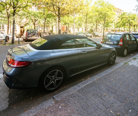 STRASBOURG, FRANCE - JUN 30, 2018: Luxury Gray Mercedes Benz C180 convertible parked on a French street in calm neighborhood with beautiful houseのeditorial素材