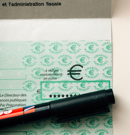 PARIS, FRANCE - JAN 1, 2015: Marker covering secret detail of French Cheque issued by the Direction Generale des Finances Publiques - the division of Economic Minister responsible for income taxesのeditorial素材