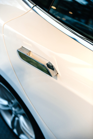 PARIS, FRANCE - NOV 29, 2014: New white Tesla Model S electric car detail with automated door handleのeditorial素材