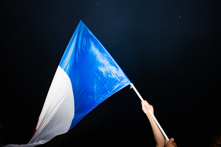 STRASBOURG, FRANCE - JULY 10, 2018: Wavbing French flag after the victory of France qualify for the final of the 2018 FIFA World Cup after their victory over Belgium 1-0のeditorial素材