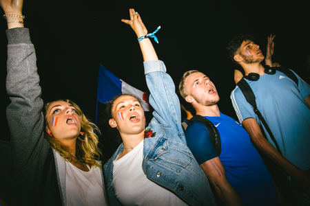 STRASBOURG, FRANCE - JULY 10, 2018: Girls celebrating on Central Place Kleber after the victory of France qualify for the final of the 2018 FIFA World Cup after their victory over Belgium 1-0のeditorial素材
