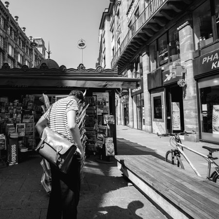 STRASBOURG, FRANCE - JUL 16, 2018: Fashionable man buying newspaper announcing France champion title after French national football team won their FIFA World Cup 2018 final game against Croatia in Moscowのeditorial素材