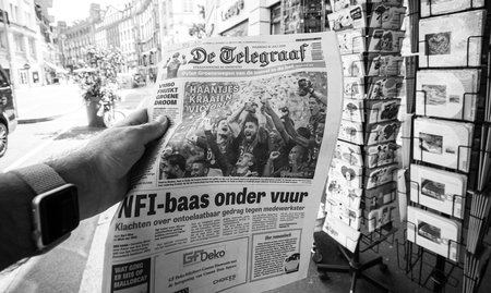 PARIS, FRANCE - JUL 16, 2018: Man buying De Telegraaf newspaper announcing France champion title after French national football team won their FIFA World Cup 2018 final game against Croatia in Moscowのeditorial素材