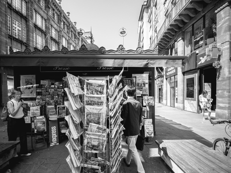 STRASBOURG, FRANCE - JUL 16, 2018: Man buying at kiosk newspaper announcing France champion title after French national football team won their FIFA World Cup 2018 final game against Croatia in Moscowのeditorial素材