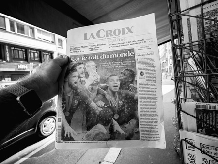 PARIS, FRANCE - JUL 16, 2018: Man buying La Croix newspaper announcing France champion title after French national football team won their FIFA World Cup 2018 final game against Croatia in Moscowのeditorial素材