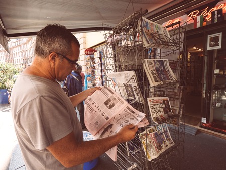 PARIS, FRANCE - JUL 16, 2018: Smoking man buying  newspaper announcing France champion title after French national football team won their FIFA World Cup 2018 final game against Croatia in Moscowのeditorial素材