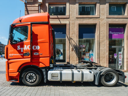 STRASBOURG, FRANCE - JUL 16, 2018: New powerful Mercedes-Benz Actros truck parked on city street near shopping stores - side viewのeditorial素材