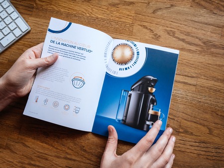 PARIS, FRANCE - JUL 1, 2018: View from above POV advertising leaflet catalogue from Nespresso espresso machines brew espresso coffee coffee capsules with machines for home or professional useのeditorial素材
