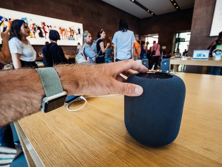 PARIS, FRANCE - JUL 16, 2018: Man touching Siri new Apple Store the latest Apple Computers HomePod smart speaker with Siri and Apple Musicのeditorial素材