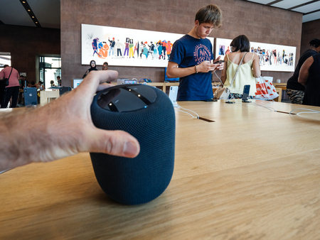 PARIS, FRANCE - JUL 16, 2018: Man hand admiring new Apple Store the latest Apple Computers HomePod smart speaker with Siri and Apple Musicのeditorial素材