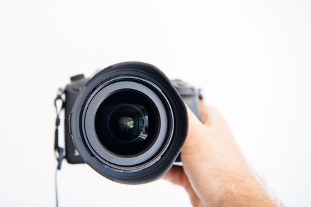 New ultra wide mirrorless camera in male handの写真素材