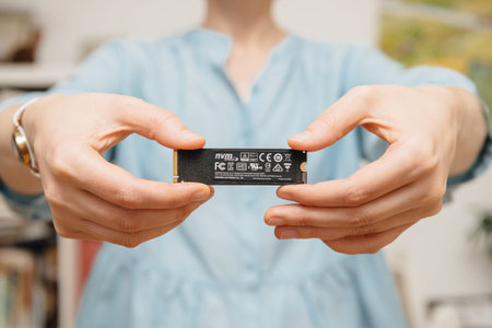 Woman hands holding new NVME PCIE SSD hard drive disk with high read and write speed