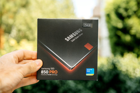 PARIS, FRANCE - AUG 3, 2018: Man hand holding packaging box of NVME PCIE SSD hard drive disk with...