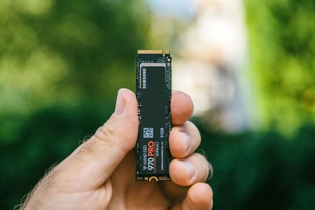 PARIS, FRANCE - JUL 27, 2018: Man hand holding new Samsung 870 Pro NVME PCIE SSD hard drive disk with high read and write speed Samsung 870 Pro - vertical holding ssd nvmeのeditorial素材