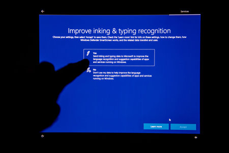 LONDON, UNITED KINGDOM - JUL 23, 2018: Hand interacting on digital touchscreen after Microsoft...