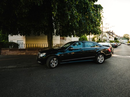 STRASBOURG, FRANCE - JUL 18, 2018: Luxury Mercedes-Benz limousine parked under a tree on a French streetのeditorial素材