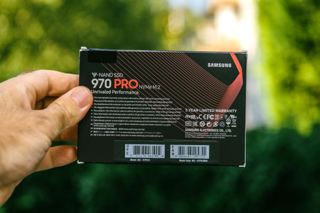 PARIS, FRANCE - AUG 3, 2018: Man hand holding packaging box of NVME PCIE SSD hard drive disk with...