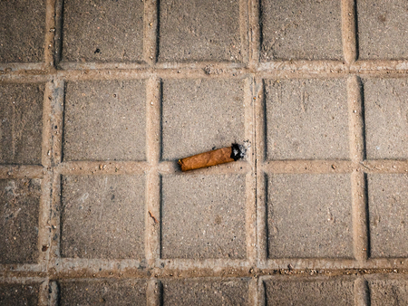 Above view of cuban cigar stub on gray concrete pavementの写真素材