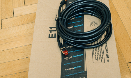 PARIS, FRANCE - SEP 12, 2016: Unboxing of new Internet Black professional RJ45 Cat 10 cable for the wired internet connect bought online from Amazon Premium Prime Ecommerceのeditorial素材