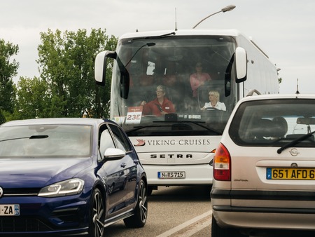 KEHL, GERMANY - APR 28, 2018: Exterior view of woman driving modern MAN tourist bus coach down city street in daylight crossing French German borderのeditorial素材