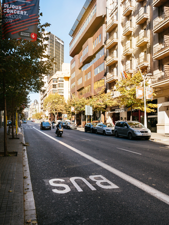 BARCELONA, SPAIN - OCT 11, 2017: View of Barcelona street with modern buildings and cars parked on side, Spain with bus special laneのeditorial素材