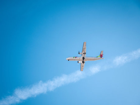 LISBON, PORTUGAL - FEB 10, 2018: From below shot of big white plane flying high in blue sky Tap...