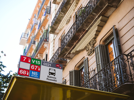 BARCELONA, SPAIN - OCT 11, 2017: From below shot of bus station with small boards showing numbers of passing routes Balmes Rosselloのeditorial素材