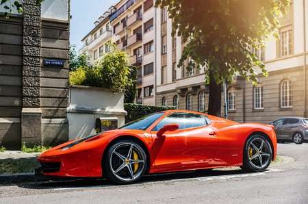 STRASBOURG, FRANCE - MAY 28, 2018: City parking with expensive luxury Ferrari car red color parked on street in sunlightのeditorial素材