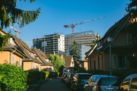 STRASBOURG, FRANCE - SEP 12, 2018: Construction of high rise skyscrapers buildings with construction crane as seen from the calm neighborhood in Strasbourg near European Parliamentのeditorial素材