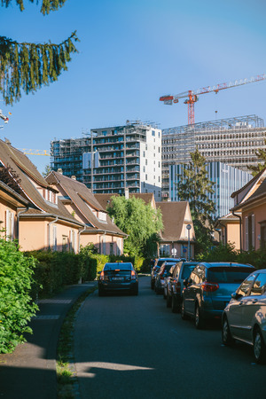 STRASBOURG, FRANCE - SEP 12, 2018: Construction of high rise skyscrapers buildings with construction crane as seen from the calm neighborhood in Strasbourg near European Parliamentのeditorial素材
