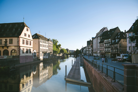 STRASBOURG, FRANCE - SEP 12, 2018: Ill river with Quai des Bateliers renowned piers perspective view early in the morningのeditorial素材